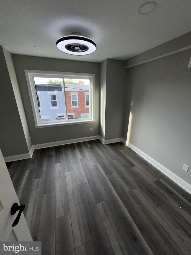 empty room with dark hardwood / wood-style floors