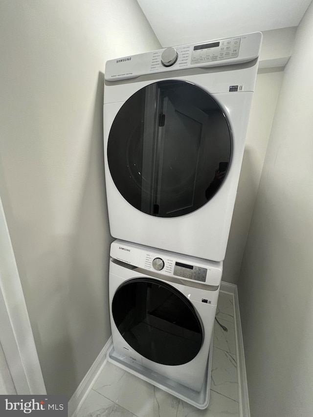 washroom with stacked washing maching and dryer