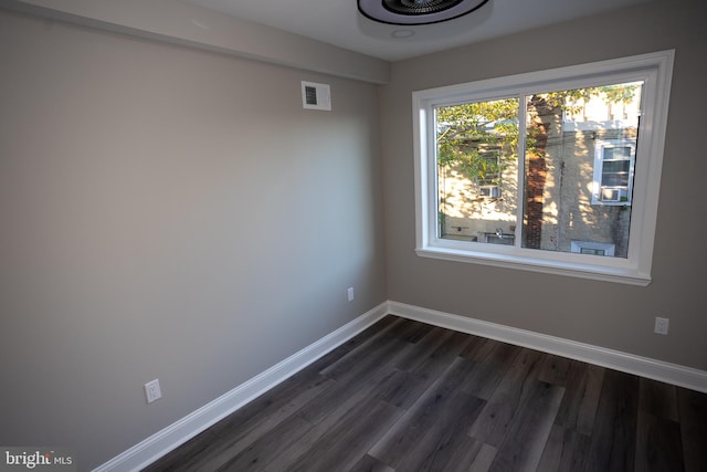 spare room with dark hardwood / wood-style floors