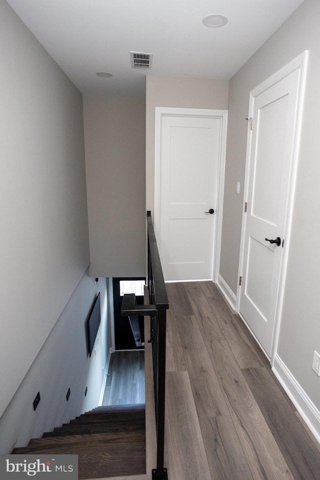 stairway with hardwood / wood-style flooring