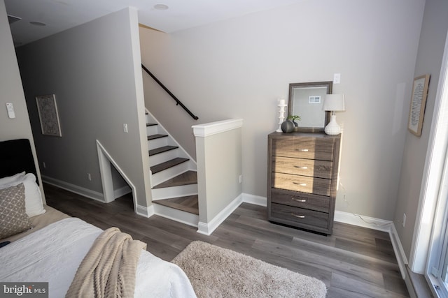 stairway with hardwood / wood-style floors