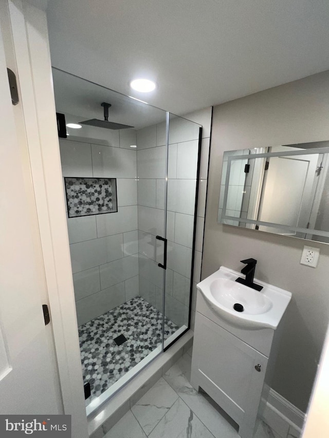 bathroom featuring vanity and a shower with shower door