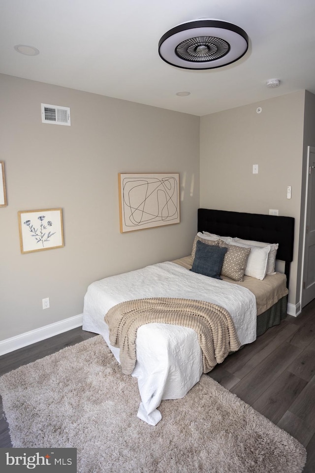 bedroom with dark hardwood / wood-style flooring