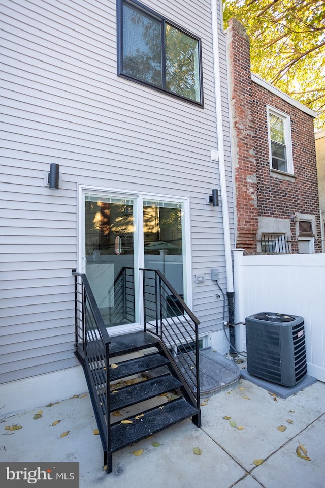 rear view of property featuring central air condition unit