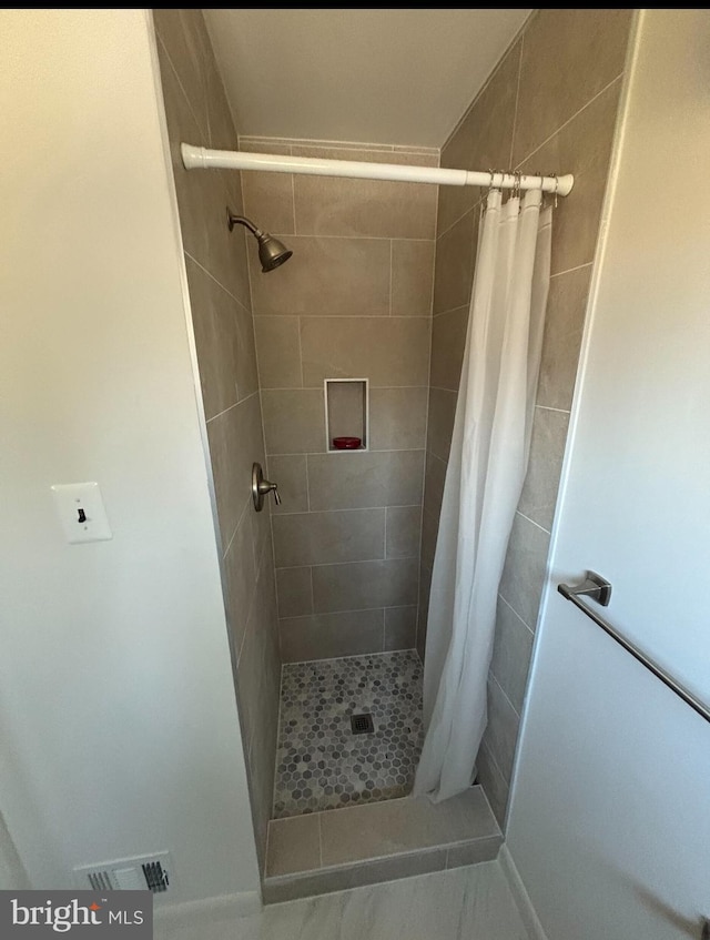 bathroom with a shower with shower curtain