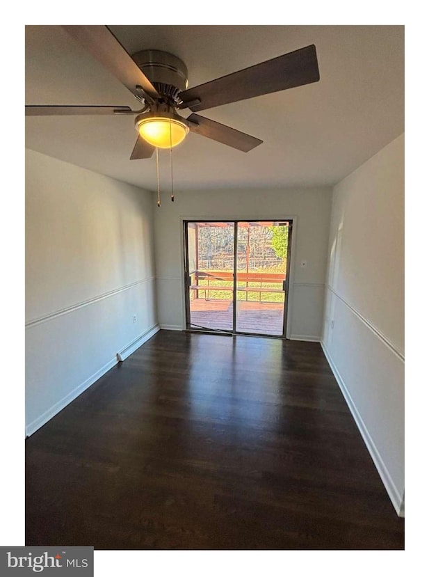 unfurnished room with dark hardwood / wood-style floors and ceiling fan