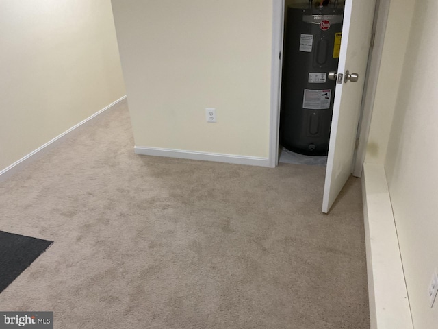 interior space featuring light colored carpet and electric water heater