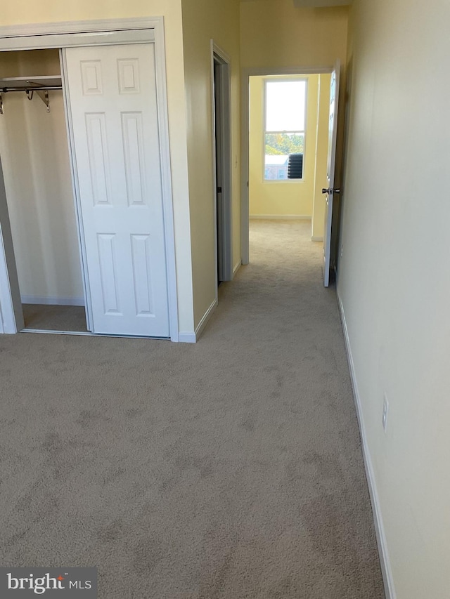 hallway with light colored carpet