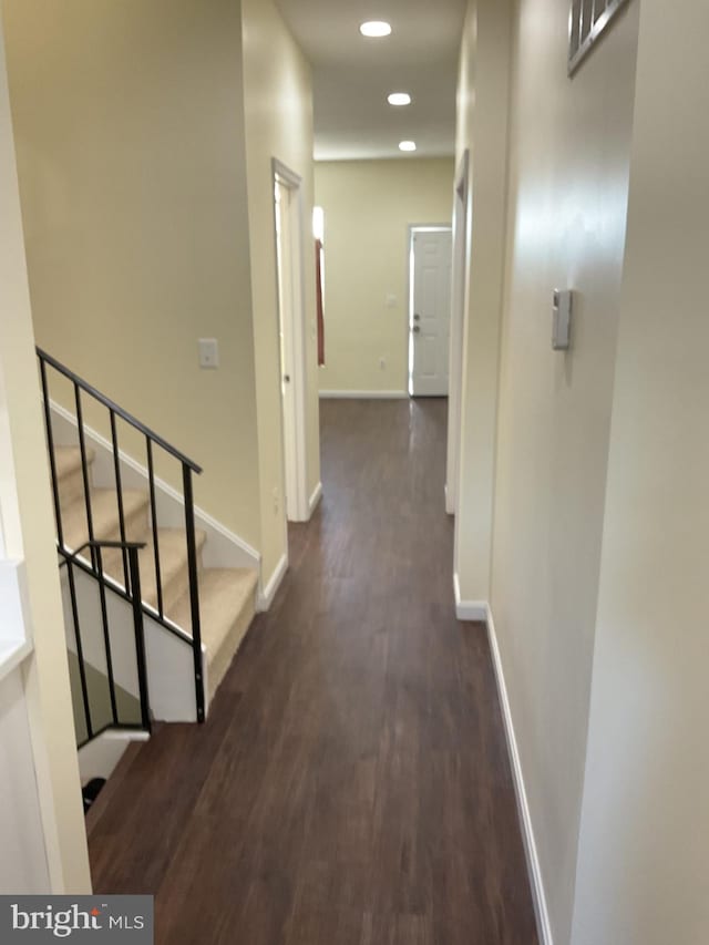 hallway with dark hardwood / wood-style floors