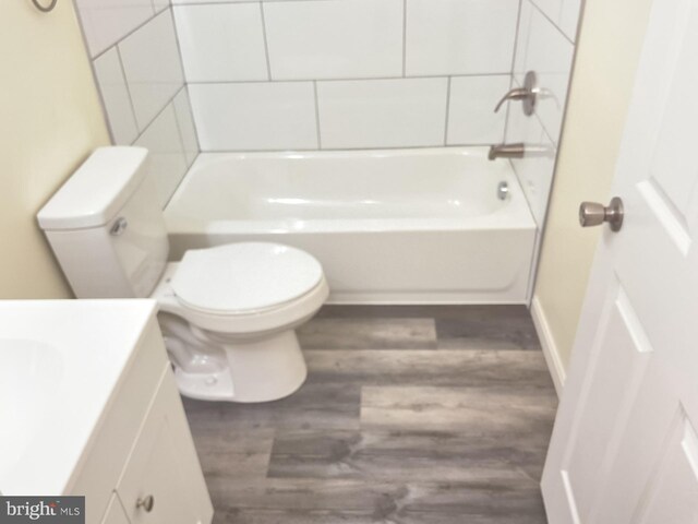 full bathroom featuring vanity, wood-type flooring, bathing tub / shower combination, and toilet