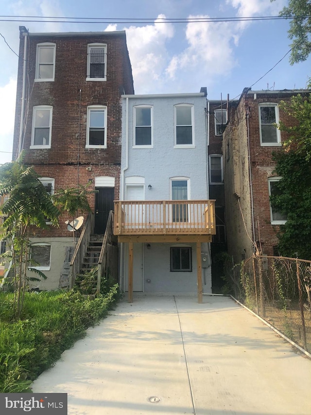 back of house featuring a deck