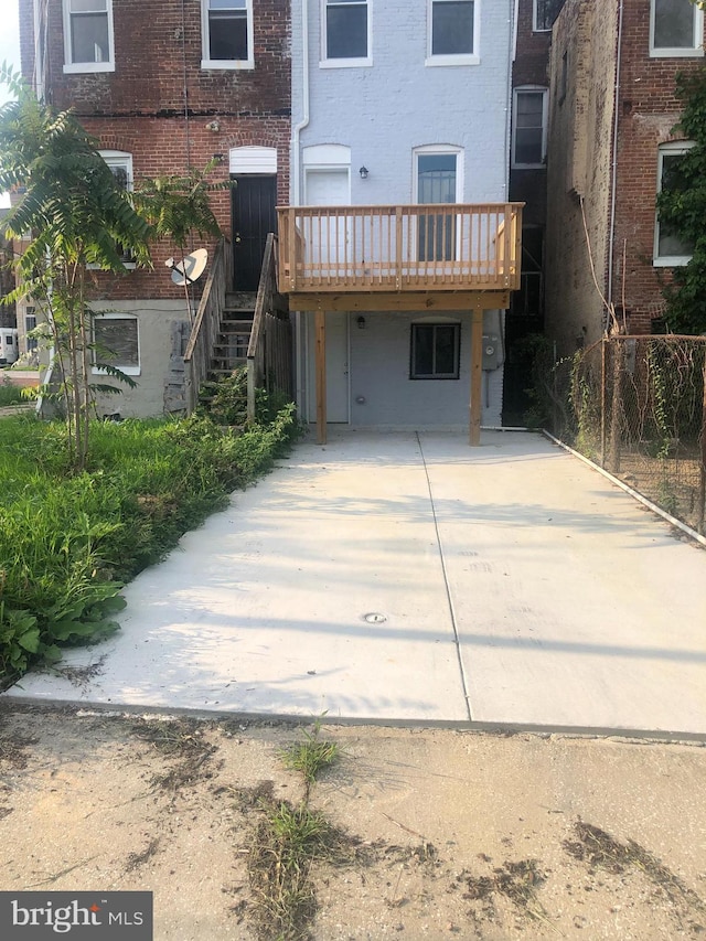 rear view of property featuring a deck