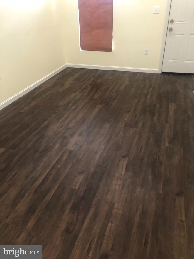 unfurnished room featuring dark hardwood / wood-style flooring