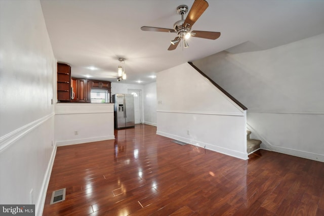 unfurnished living room featuring ceiling fan and wood-type flooring