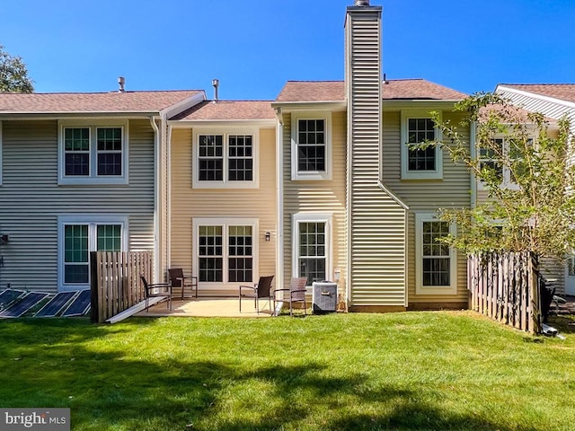 back of house with a lawn, a patio area, and central AC unit