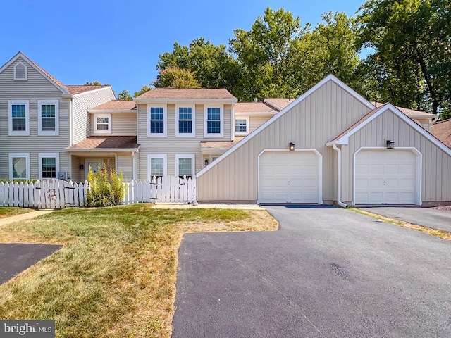 view of front of house with a front yard and a garage