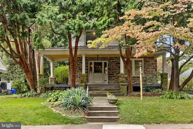 view of front of house with a front yard and a porch