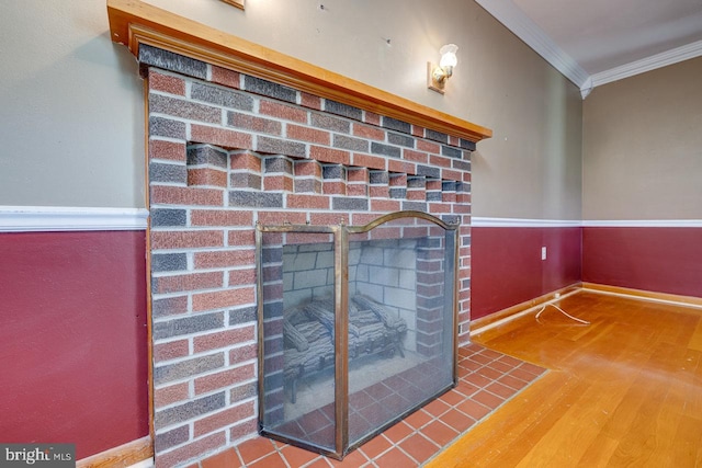 interior details featuring a fireplace, crown molding, and hardwood / wood-style flooring