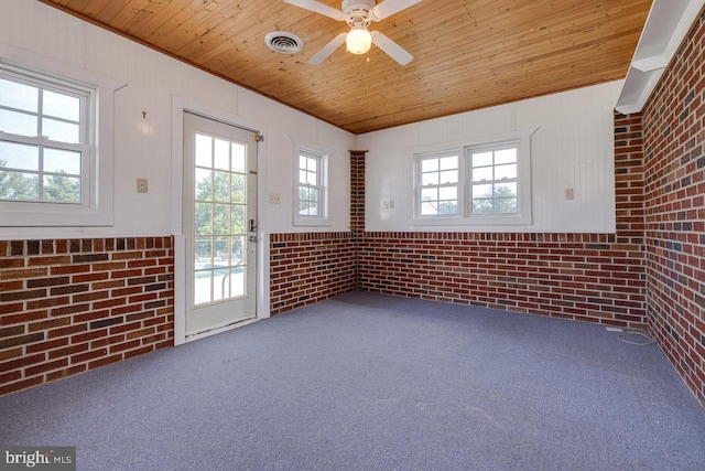 carpeted spare room with wood ceiling, ceiling fan, and a healthy amount of sunlight