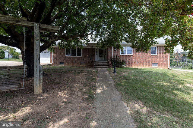 ranch-style home featuring a garage and a front yard