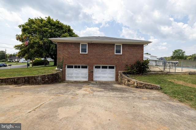 view of home's exterior with a garage and a yard