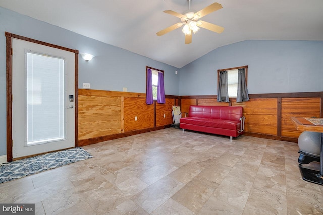 interior space with plenty of natural light, ceiling fan, vaulted ceiling, and light tile patterned flooring