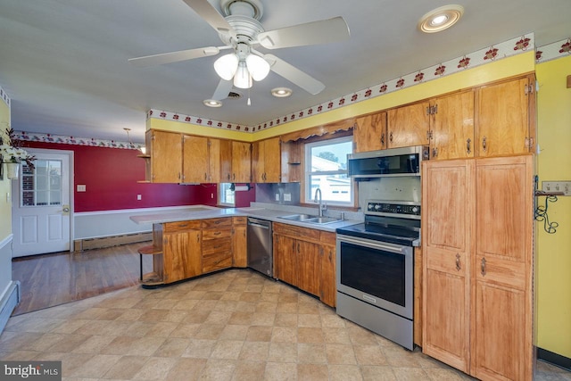 kitchen featuring a baseboard radiator, ceiling fan, sink, appliances with stainless steel finishes, and light tile patterned flooring