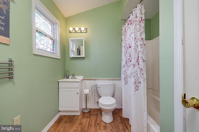 full bathroom with hardwood / wood-style flooring, vaulted ceiling, toilet, shower / tub combo, and vanity