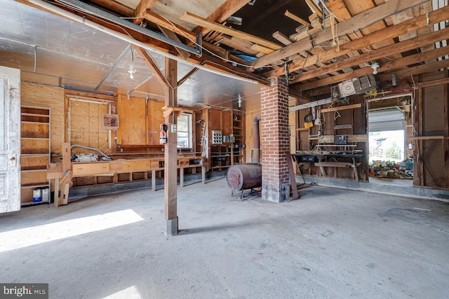 miscellaneous room with a workshop area and brick wall