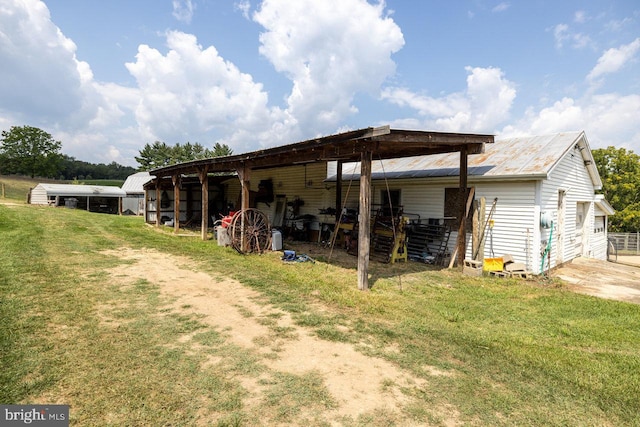 rear view of property featuring an outbuilding