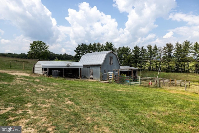 view of yard with an outdoor structure and a rural view