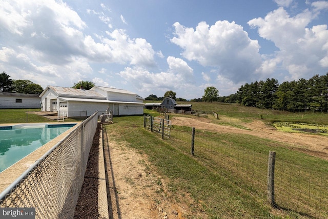 view of yard with a rural view and a fenced in pool