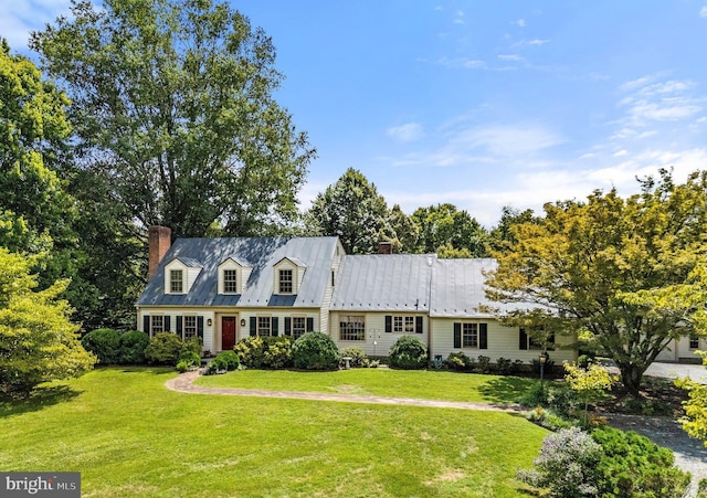 cape cod-style house with a front yard