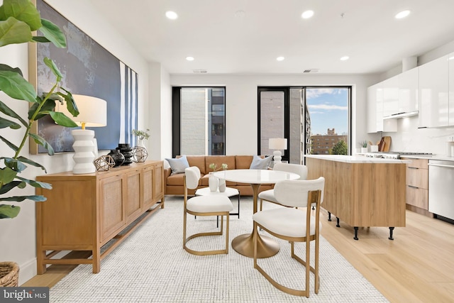 interior space featuring light wood-type flooring, visible vents, and recessed lighting