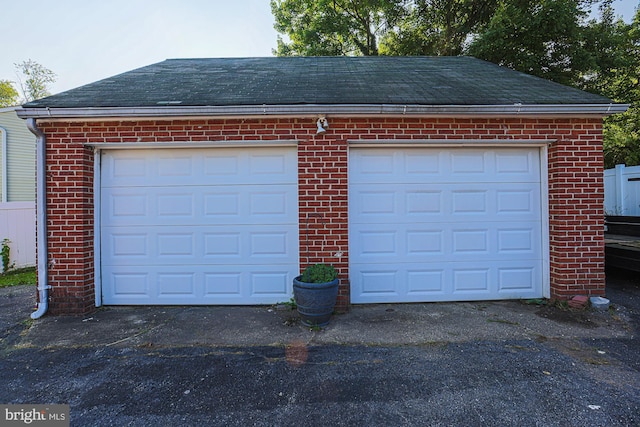 garage with aphalt driveway