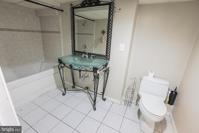 bathroom with baseboards, tub / shower combination, toilet, and tile patterned floors