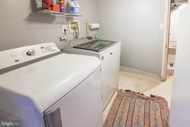 washroom featuring laundry area, washing machine and dryer, and baseboards