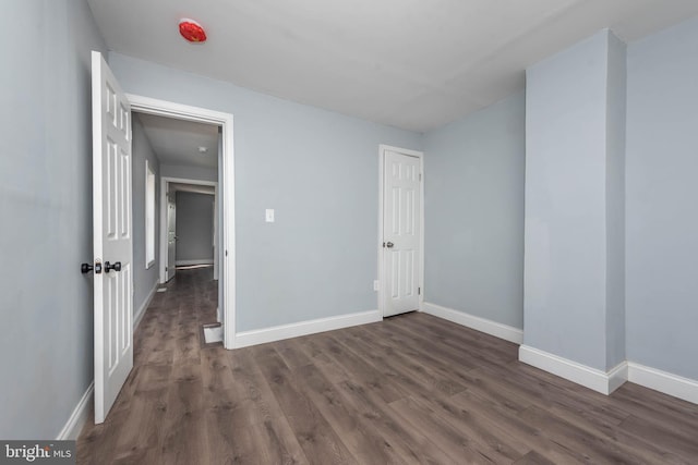 unfurnished bedroom featuring dark hardwood / wood-style flooring