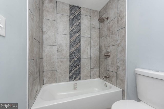 bathroom featuring toilet and tiled shower / bath combo