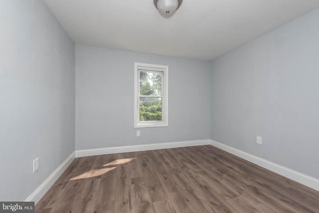 unfurnished room with dark hardwood / wood-style floors