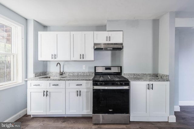 kitchen with sink, wood-type flooring, light stone countertops, ventilation hood, and stainless steel gas range