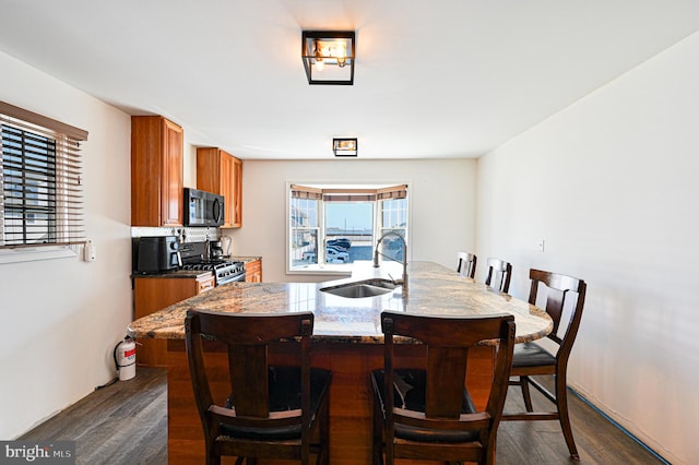 dining area featuring dark wood-type flooring and sink