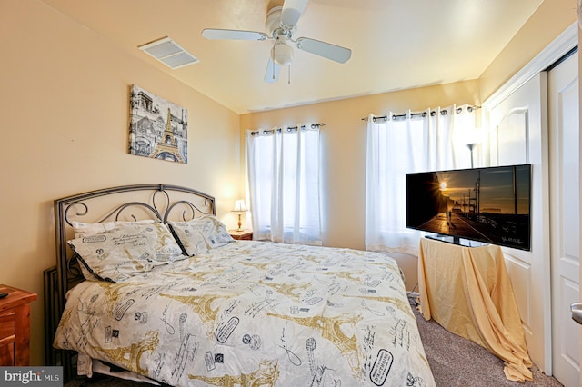 carpeted bedroom with a ceiling fan and visible vents