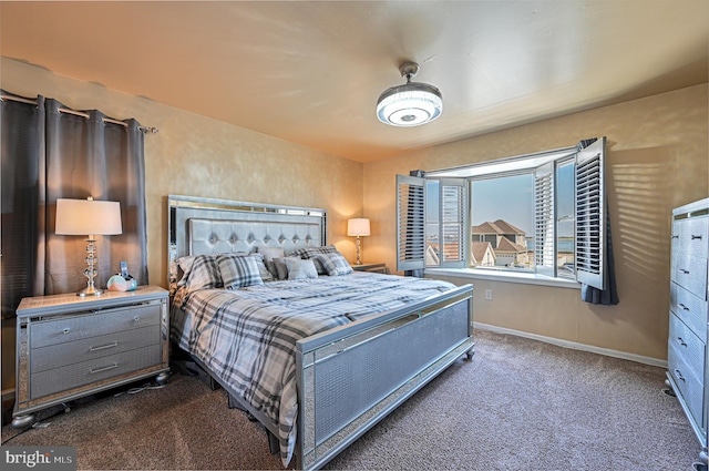 bedroom with dark colored carpet