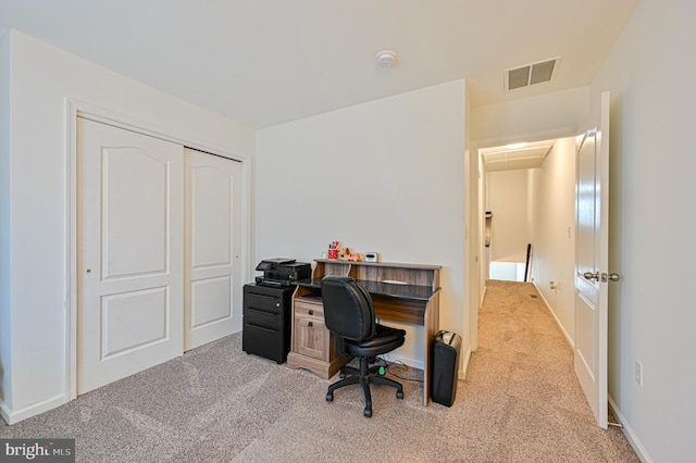 office space with carpet, visible vents, and attic access