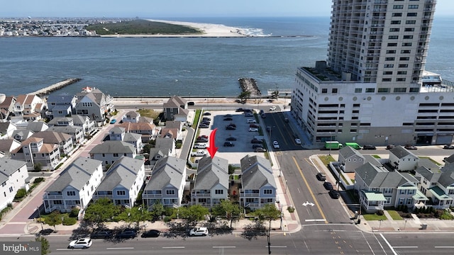 drone / aerial view featuring a water view and a residential view