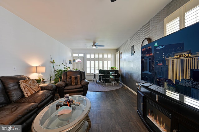 living room with dark wood-type flooring and ceiling fan