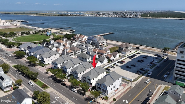 birds eye view of property with a water view and a residential view