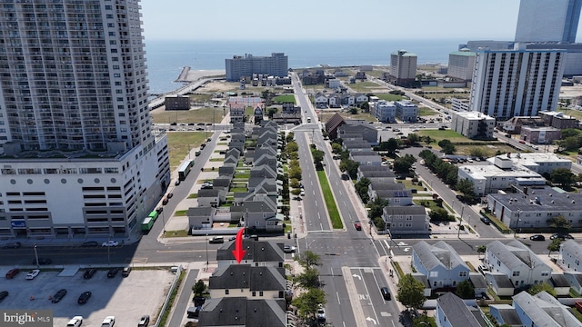 birds eye view of property with a water view and a city view