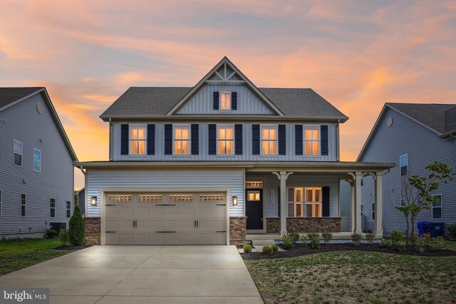 craftsman inspired home with a garage and a porch